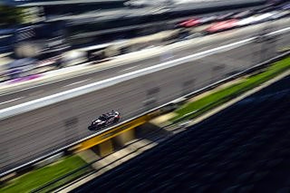 The #90 speeding past on a long straight at Indianapolis