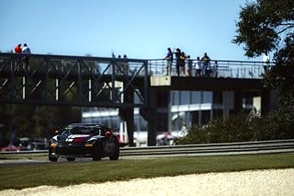 The #90 approaching a pedestrian bridge at Barber