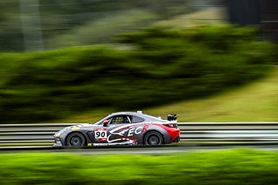 Side view of the #90 in the rain at Barber