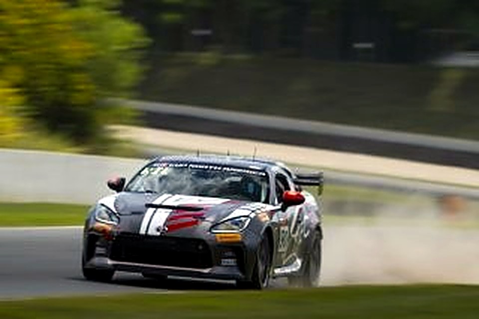 The #90 kicking up dust on corner exit at Road America