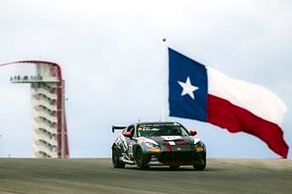 The #90 passing the Texas flag at Circuit of The Americas