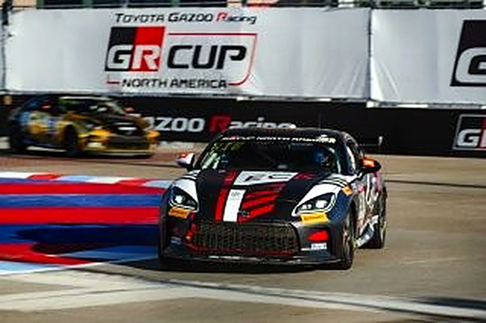 The #90 on the Arlington street course in front of a GR Cup banner