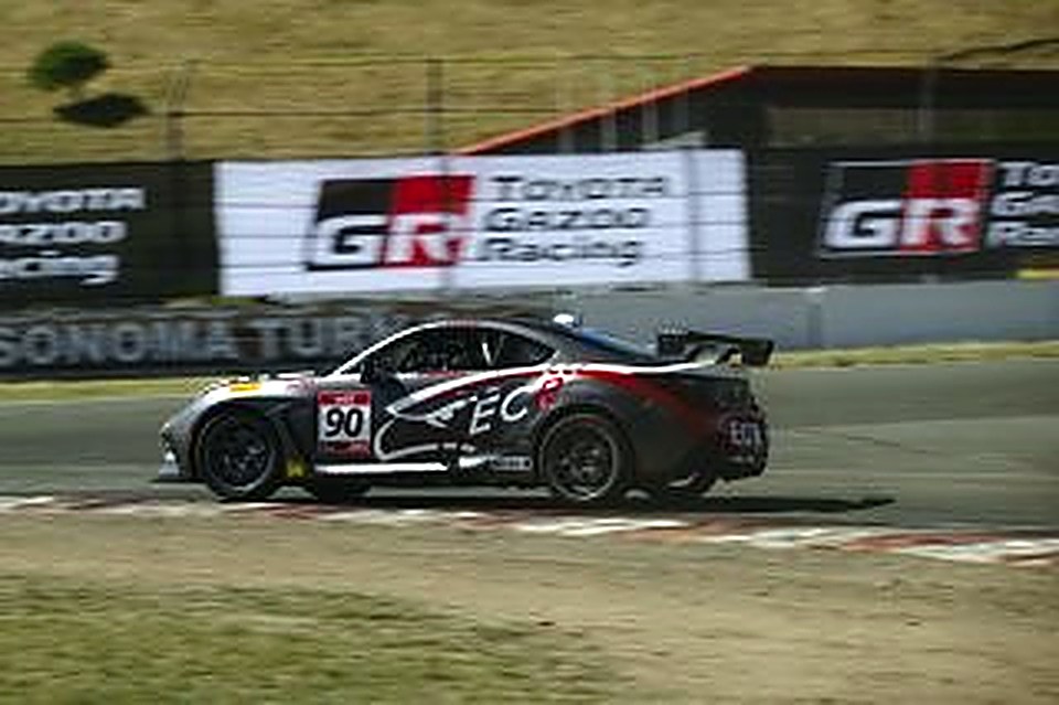 Side profile of the #90 under a Toyota Gazoo Racing banner at Sonoma